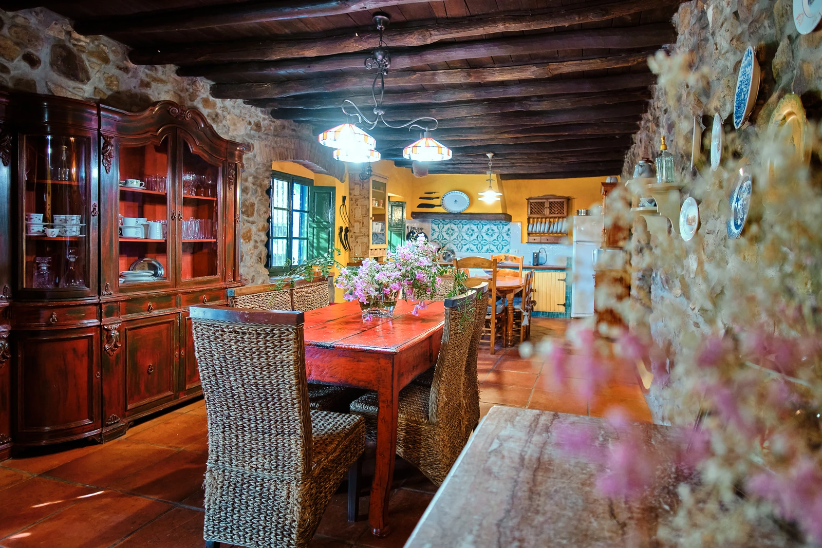 Salón comedor con paredes de piedra y vigas de madera. · Casa Rural Juanpere