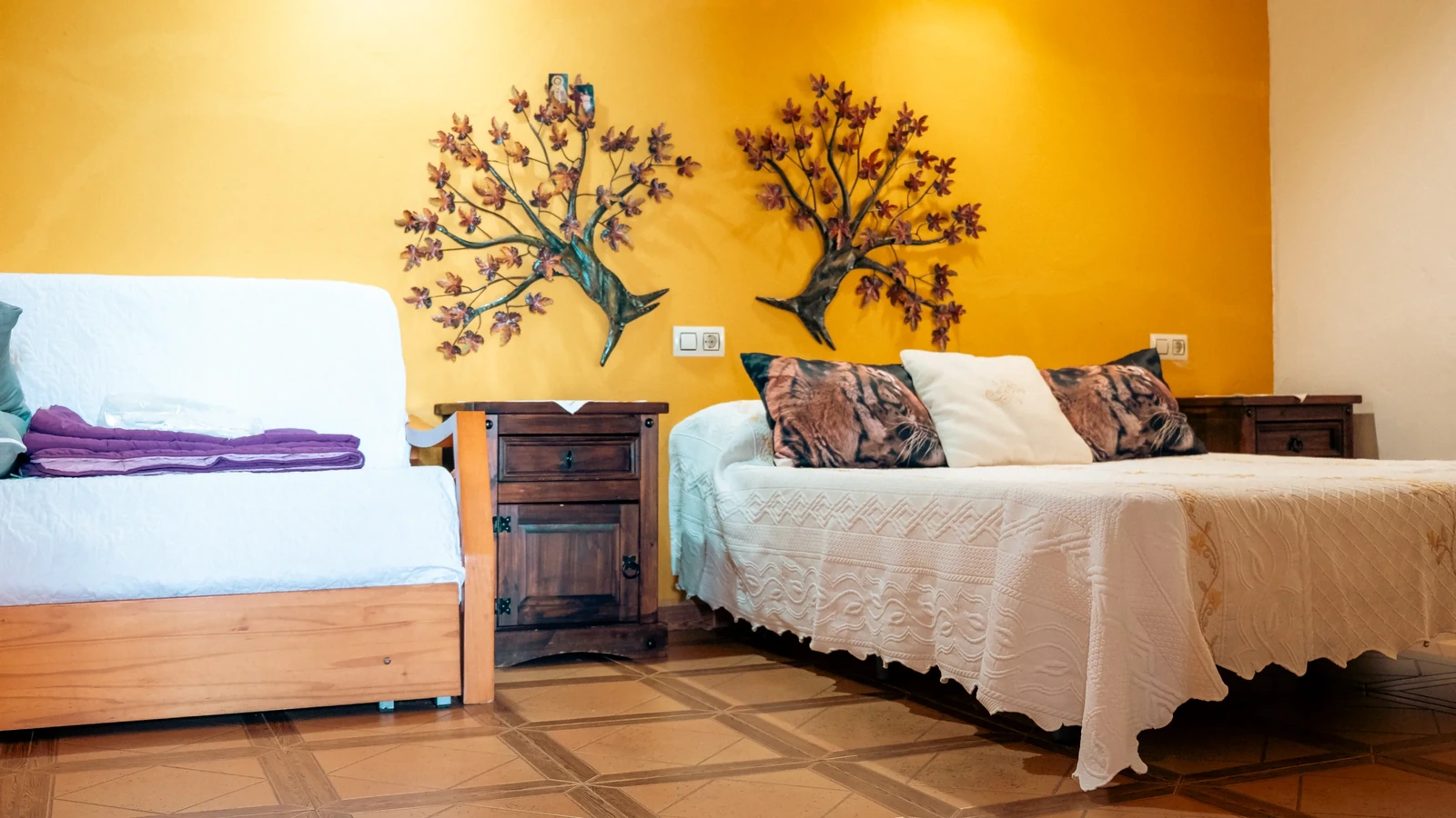Dormitorio con pared amarilla de una casa del complejo. · El Rincón de Cabañeros
