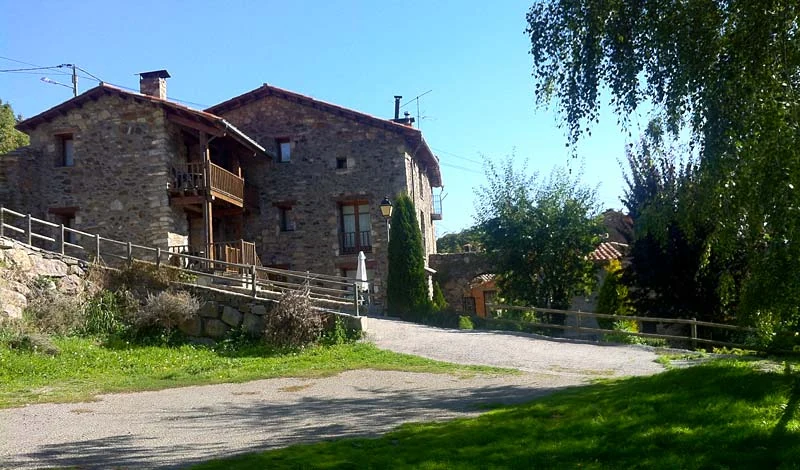 Fachada de piedra y jardín de Mas Batlló